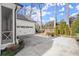 View of the backyard, detached garage and the outdoor kitchen and grill area at 220 Chastain Park Ne Dr, Atlanta, GA 30342