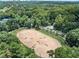 Aerial view of an equestrian center, an open-air riding ring with obstacles and seating for spectators at 220 Chastain Park Ne Dr, Atlanta, GA 30342