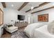 Comfortable main bedroom featuring wooden beams, light-colored furniture and accent rug at 220 Chastain Park Ne Dr, Atlanta, GA 30342