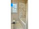 This bathroom showcases marble-style tile from the floor and up the back wall of the tub at 2213 Sandtown Sw Rd, Marietta, GA 30060