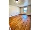 Bedroom with hardwood floors, a large window and a view of the back yard at 2213 Sandtown Sw Rd, Marietta, GA 30060
