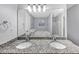 Bathroom features double sinks with granite countertops and a soaking tub beyond the mirror at 5724 Antelope Trl, Atlanta, GA 30349