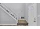 Bright foyer with a staircase featuring white railings and carpeted steps at 5724 Antelope Trl, Atlanta, GA 30349