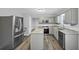 Modern kitchen featuring stainless steel appliances, granite countertops, and gray cabinets at 5724 Antelope Trl, Atlanta, GA 30349