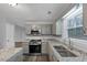 Well-lit kitchen with granite countertops, stainless steel appliances, and neutral gray cabinetry at 5724 Antelope Trl, Atlanta, GA 30349