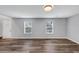 Spacious living room featuring wood-look floors and ample natural light from two windows at 5724 Antelope Trl, Atlanta, GA 30349