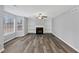Cozy living room featuring wood-look floors, a fireplace, and built-in bookshelves at 5724 Antelope Trl, Atlanta, GA 30349