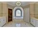 This bathroom is fitted with double vanities, shower stall, and a soaking tub underneath a stained glass window at 7910 St Marlo Country Club Pkwy, Duluth, GA 30097