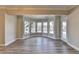 Living room featuring a large window bay, wood floors, and neutral wall color at 7910 St Marlo Country Club Pkwy, Duluth, GA 30097