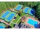 Aerial view of resort style tennis courts, cabana and pool surrounded by lush mature trees and landscaping at 7910 St Marlo Country Club Pkwy, Duluth, GA 30097