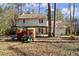 Large, fenced backyard with mature trees, play set, and a covered patio great for outdoor living at 3043 Chelsea Ln, Acworth, GA 30102