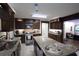 Spacious kitchen featuring dark wood cabinets, granite countertops, stainless steel appliances, and a central island at 402 Rising Cir, Woodstock, GA 30189