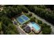 Aerial view of community amenities, including pool and tennis courts, surrounded by trees at 4569 Campenille Trce, Suwanee, GA 30024