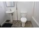 Simple bathroom features a sink and vanity with toilet and tiled flooring at 4569 Campenille Trce, Suwanee, GA 30024