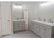 Bright bathroom boasts double vanities, stylish fixtures, and neutral decor at 4569 Campenille Trce, Suwanee, GA 30024
