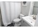 Bathroom featuring a toilet, shower with white curtain, and modern vanity at 4569 Campenille Trce, Suwanee, GA 30024