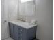 Bathroom with blue vanity, marble countertop and tiled floors at 4569 Campenille Trce, Suwanee, GA 30024