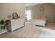 Bedroom decorated with dresser, rug, and queen-size bed, featuring a white frame, and neutral walls at 4569 Campenille Trce, Suwanee, GA 30024