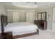 Spacious bedroom with neutral walls, carpet floors, and ensuite bathroom access at 4569 Campenille Trce, Suwanee, GA 30024