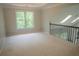 Bonus room with light carpet, trim and paint, and a window overlooking the backyard at 4569 Campenille Trce, Suwanee, GA 30024