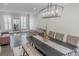 Charming dining room featuring a sleek chandelier, shuttered windows, and dark wood floors at 4569 Campenille Trce, Suwanee, GA 30024