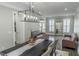 Elegant dining room with a modern chandelier, shuttered windows, and an expansive dining table at 4569 Campenille Trce, Suwanee, GA 30024