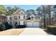 Charming two-story home boasts a manicured lawn and a two-car garage at 4569 Campenille Trce, Suwanee, GA 30024