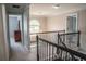Upstairs landing featuring wrought iron railing and decorative lighting fixture at 4569 Campenille Trce, Suwanee, GA 30024
