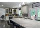 Bright kitchen featuring stainless steel appliances, white cabinetry, a large island, and a deck at 4569 Campenille Trce, Suwanee, GA 30024