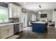 Open kitchen with white cabinets, stainless steel appliances, and an island with barstool seating at 4569 Campenille Trce, Suwanee, GA 30024