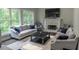 Comfortable living room with plush seating, large windows, fireplace, and a neutral color palette at 4569 Campenille Trce, Suwanee, GA 30024