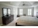 Serene main bedroom with tray ceilings, neutral tones, a large dresser, and abundant natural light at 4569 Campenille Trce, Suwanee, GA 30024