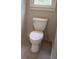 Close-up of a standard white toilet against neutral wall, complimented by sleek gray tile flooring at 4569 Campenille Trce, Suwanee, GA 30024