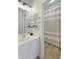 Bathroom featuring a sink and a shower with a tan and white striped curtain and light hard wood flooring at 5046 Sara Creek Way, Sugar Hill, GA 30518