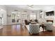 Bright living room featuring hardwood floors, fireplace, and ample natural light at 5046 Sara Creek Way, Sugar Hill, GA 30518