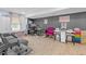 Open basement area with grey walls, furniture and tile flooring at 582 Braidwood Nw Dr, Acworth, GA 30101