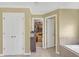 Neutral-toned bathroom with double doors, walk-in closet, and tiled bathtub at 582 Braidwood Nw Dr, Acworth, GA 30101
