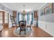 Elegant dining room featuring hardwood floors, and large windows with blue accents at 582 Braidwood Nw Dr, Acworth, GA 30101