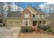 Attractive home showcasing a stone facade, a two-car garage, and a beautifully landscaped front yard at 582 Braidwood Nw Dr, Acworth, GA 30101