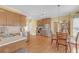 Well-lit kitchen featuring stainless steel appliances, light countertops, and a cozy breakfast nook area at 582 Braidwood Nw Dr, Acworth, GA 30101