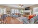 Inviting living room with hardwood floors, a stone fireplace, and ample natural light from large windows at 582 Braidwood Nw Dr, Acworth, GA 30101