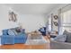 Comfortable living room with a sectional couch, large windows, and hardwood floors at 582 Braidwood Nw Dr, Acworth, GA 30101