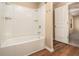 Full bathtub with a white surround and wood-look flooring at , Fairburn, GA 30213