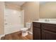 Cozy bathroom with a tub/shower combo, dark wood vanity, and wood-look flooring at , Fairburn, GA 30213