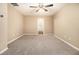 Spacious carpeted bedroom with ceiling fan and neutral color scheme at , Fairburn, GA 30213