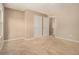Large, carpeted bedroom with two doors and neutral paint at , Fairburn, GA 30213