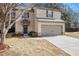 Charming two-story home with a gray 2-car garage, dark trimmed windows and a well-manicured lawn at , Fairburn, GA 30213