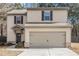 Two-story home featuring a 2-car garage, and black trimmed windows, complemented by neutral siding and a well-maintained lawn at , Fairburn, GA 30213