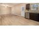 Bright, airy living room with light wood flooring, seamlessly connecting to the kitchen. Features a ceiling fan and natural light at , Fairburn, GA 30213
