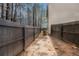 Narrow side yard with a wooden fence, offering privacy and a walkway along the home's exterior at , Fairburn, GA 30213